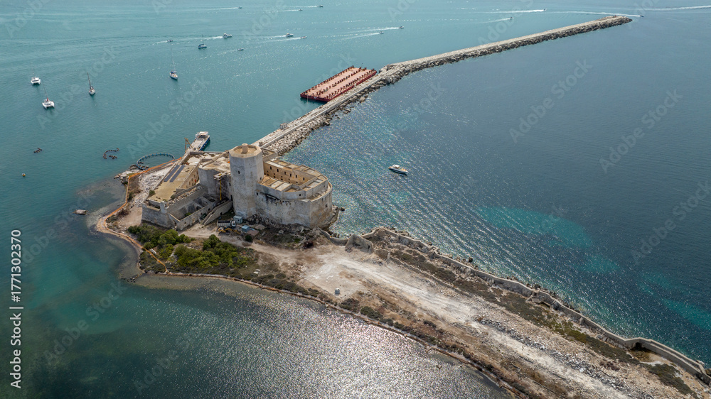 Fototapeta premium Aerial view of La Colombaia, also known as Torre Peliade or Castello di Mare. It is a medieval fortress, with a tower, located on a small island in the bay of Trapani, Sicily, Italy.
