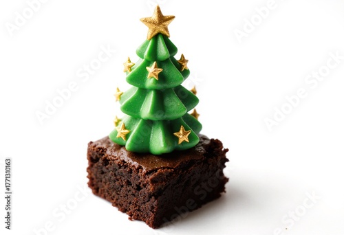 Decorative Christmas tree made of green frosting and golden stars atop a rich chocolate brownie