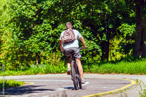 Wallpaper Mural Cyclist ride on the bike path in the city Park
 Torontodigital.ca