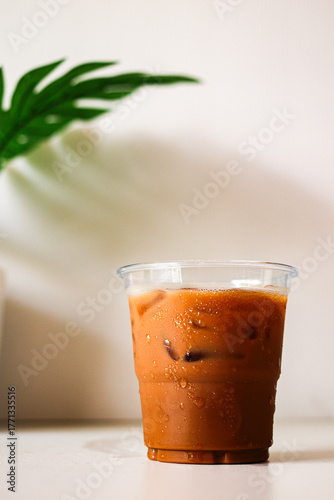Iced coffee in glass cup on white table