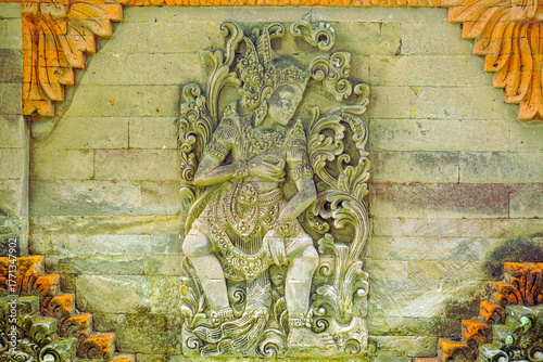 Ancient Balinese Stone Carving of a Deity in Traditional Dance Pose