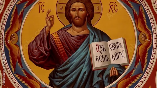 An Orthodox church fresco depicting the face of Jesus Christ holding an open book. The sacred image symbolizes divine wisdom, faith, and spiritual guidance in Christian tradition.