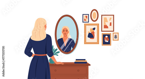 Beautiful blonde woman in a blue dress stands in front of a mirror, admiring her reflection in a stylish room with contemporary wall art.