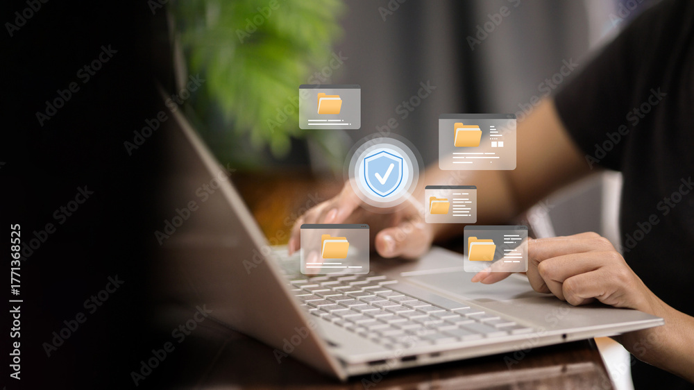 Fototapeta premium Secure document management on laptop with floating folder windows and shield check icon