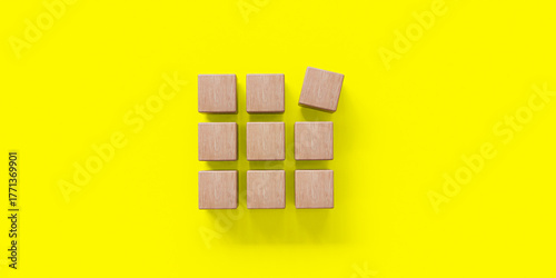 Wooden blocks neatly arranged on a yellow background, symbolizing business concept,