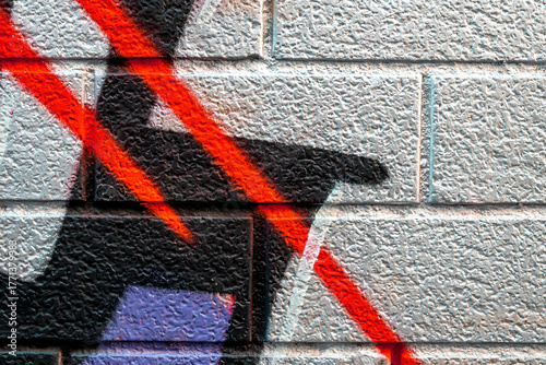 vivid street graffiti texture of colotful spray painting strips on gray metallic brick background, urban culture of modern youth backdrop