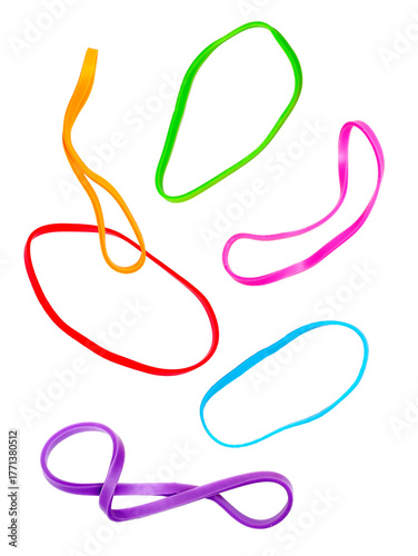 photograph of several brightly colored neon elastic rubber bands scattered and twisting randomly against a pure transparent background, school supply concept.