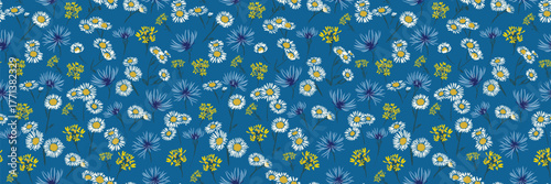 Seamless vector floral pattern with white daisies, yellow wildflowers, and blue cornflowers on a deep blue background. Designs for fabrics, wrapping paper, and spring decor