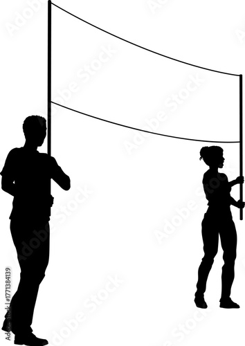 Two protestors or demonstrators at a demonstration march, picket line or strike protest rally in silhouette. Holding up a banner sign.