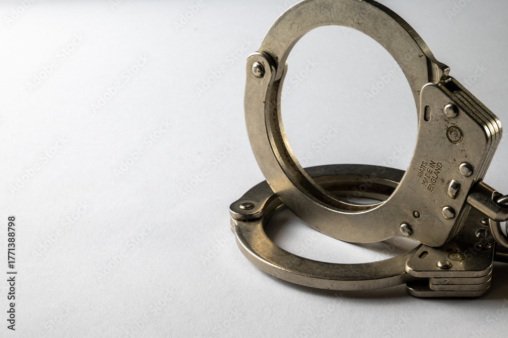 Obraz premium Metal Handcuffs and white background