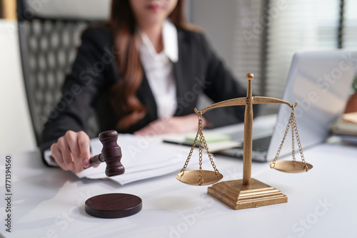 Asian lawyer working in law firm, Conceptualizing justice advice, Focuses on the judge's scales and gavel.
