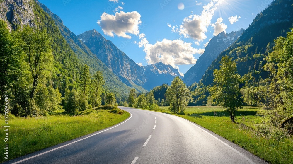 Fototapeta premium Serene Mountain Road with Lush Greenery and Clear Blue Sky