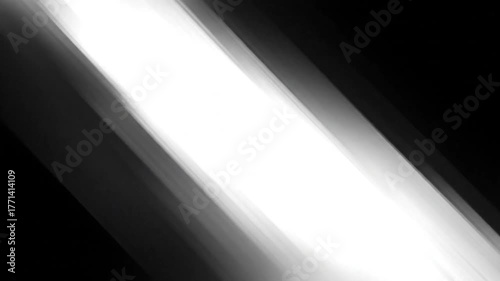 A diagonal gradient from black to white with soft edges. A central white streak appears to highlight the image