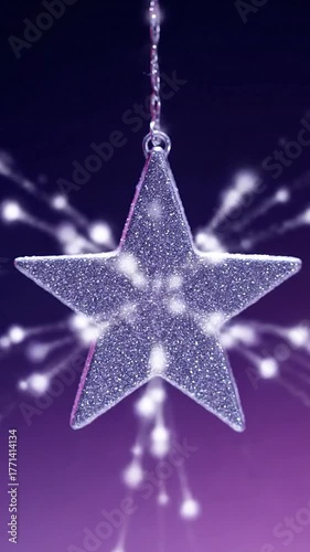 Glittering star ornament hangs, with sparkling light trails on gradient purple/dark backdrop