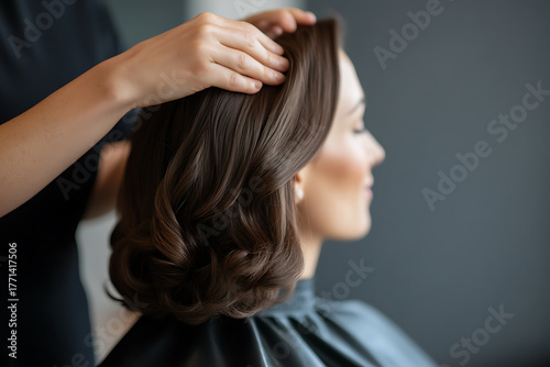 Wallpaper Mural Elegant hairstyle creation. A stylist carefully arranges soft, dark brown waves into a chic updo, perfect for a formal event. The model enjoys the pampering touch. Torontodigital.ca