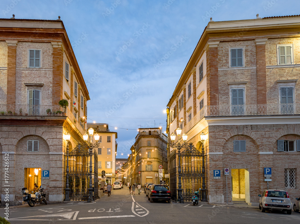 Fototapeta premium Sunset View of Macerata’s Historic Town Gate and Street