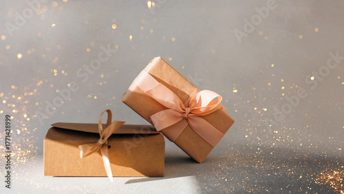 Greeting background. Brown and pink gift boxes on a gray background with copy space. Front view