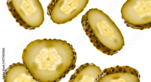 Floating dill pickle slices isolated on white