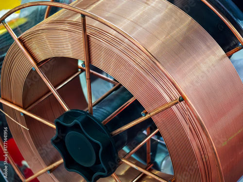 Copper wire spool displayed at a manufacturing facility for electrical components in the late afternoon