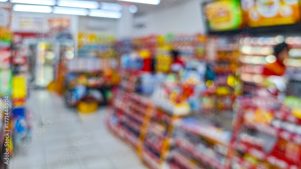 Naklejka premium Defocused photo of A supermarket store aisle with a variety of products on the shelves. abstract blur of convenience store aisle, fast moving consumer goods industry urban lifestyle concept.
