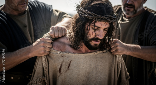 The passion of Christ with soldiers stripping his robe. Jesus wearing a crown of thorns in a dramatic biblical scene of suffering and sacrifice