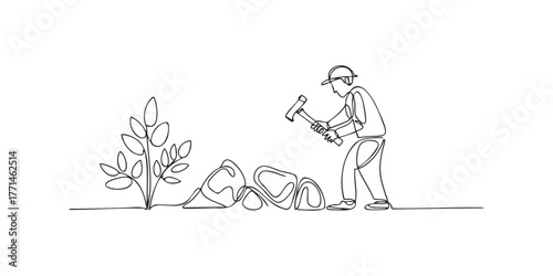 Gardener working with rocks and plants