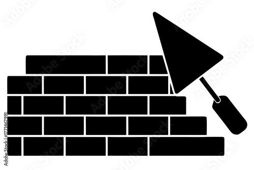 A black silhouette of a trowel applying mortar to a brick wall under construction symbolizing building and repair work silhouette