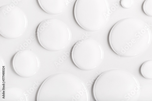 drops of transparent gel serum on gray background