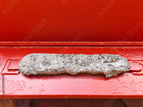 Bild auf Leinwand Corroded zinc anode on a red metal surface