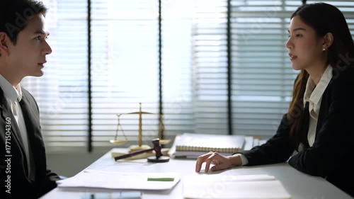 Lawyers provide support and advice to clients in the office.