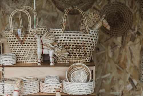 Straw baskets and a bag. Straw horse. Close-up of handmade straw crafts. An ancient method of making things from straw.