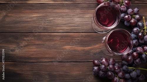 Wine glasses with grapes on rustic wooden table background