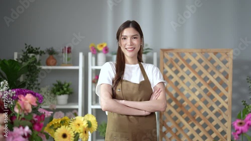 Asian employee works in a beautiful flower shop.