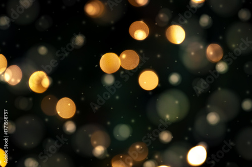 Golden bokeh lights on a dark background. Snowflakes falling down. Christmas magical light background, overlay or lens flare effect