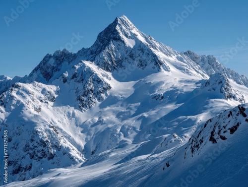 Grand Snow-Clad Alpine Mountain Range Under Bright Blue Sky, Pristine Winter Wilderness Landscape, Expansive Snowfield, Dramatic Shadows, Clear Sunny Day Mountainous Terrain