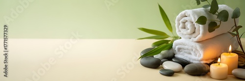 Serene spa scene with towels stones candles and greenery