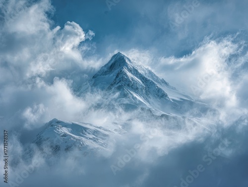 Dramatic Alpine Peak Snow-Covered Summit Clouds Swirl Blue Sky Majestic Mountain Landscape Scenic Vista High Altitude Wilderness Serene Nature Viewpoint