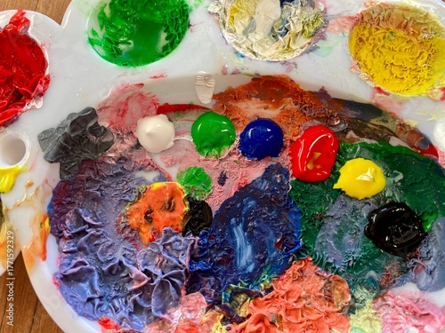 An artist's palette covered in bright colors image for background use