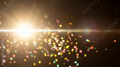 Colorful confetti sparkling in bright light beams