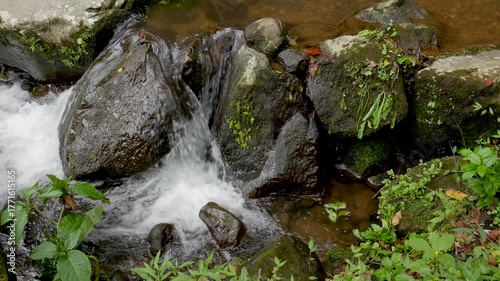 4K horizontal footage of clear water running over mossy stones in a small mountain stream. Calm and natural movement, perfect for background or meditation visuals