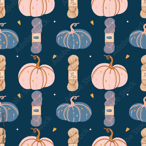 Seamless autumn pattern with hand-drawn pink and blue pumpkins, skeins of yarn, and hearts on a dark blue background. Cute and cozy autumn background. Decorative pumpkins. Pastel colors. Vector flat