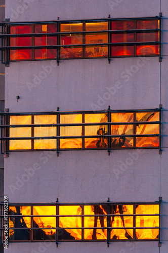 Sunrise light illuminates office building windows in Gothenburg, creating a warm and vibrant atmosphere