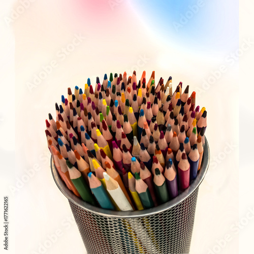 A colorful set of colored pencils in a cup isolated on white background with copy space. Concept of creativity, drawing, learning, craftsmanship.