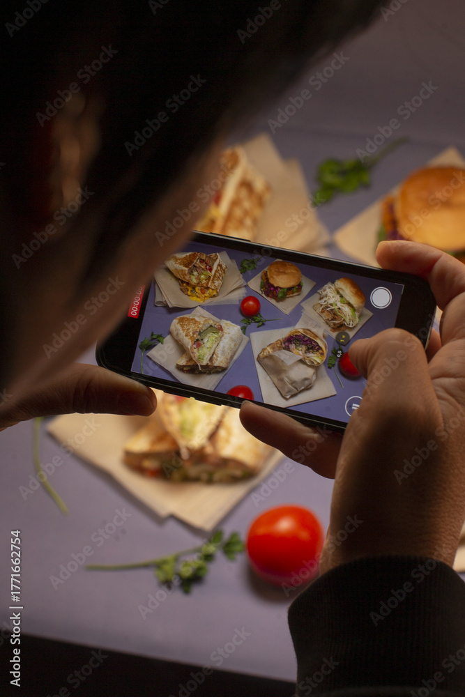 Fototapeta premium Overhead shot of culinary presentation using smartphone in cozy kitchen, Stylish food photography capturing fresh appetizers with artistic lighting and creative