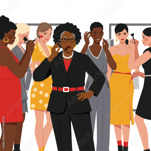 A diverse group of women, some receiving makeup applications, gather around an older woman wearing a headset
