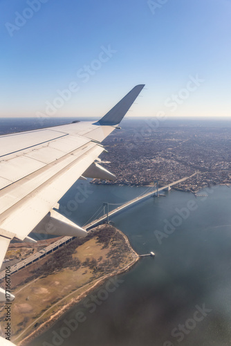 Beautiful view looking out an airplane window - Travel image with a bridge going over a river