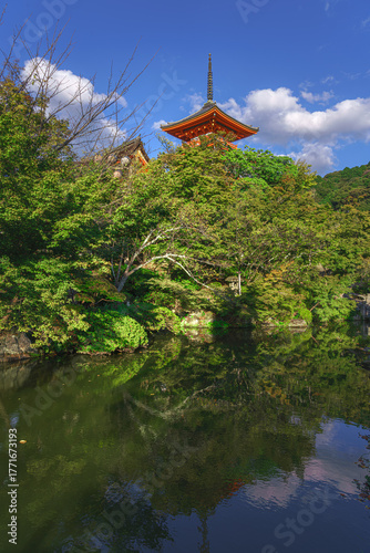 Kyoto, Japan - Oct 11 2024, panoramic view from below of the Kiyomizu-dera Temple pagoda peeking out from behind the treetops, without people, at daytime, Kyoto, Japan