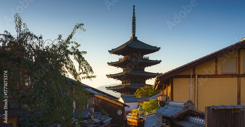 Kyoto, Japan - Oct 11 2024, Panoramic view of Yasaka Pagoda of Hōkan-ji Temple, building facades and trees in the foreground, in the evening, Kyoto, Japan