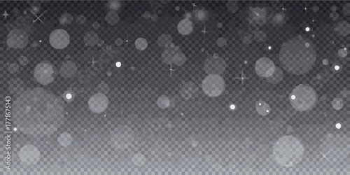 Softly falling snowflakes and bokeh lights on a transparent dark background
