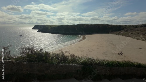 Summertime establishing shot of Barafundle Bay Beach on the Pembrokeshire coast, Wales.